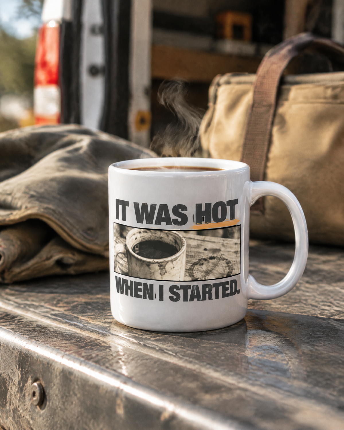 It Was Hot When I Started mug on a van tailgate